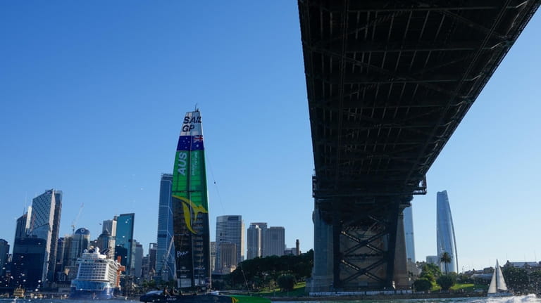 Australia sails under the Sydney Harbour Bridge after winning the...