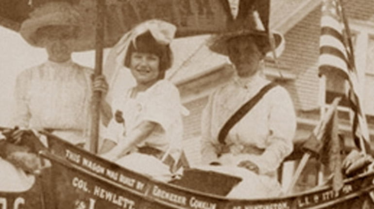 Sitting in the Suffragist wagon, from left, are Edna Buchman...