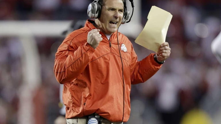 Urban Meyer of the Ohio State Buckeyes reacts during the...