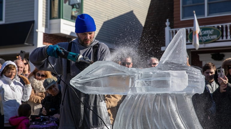 Ice sculptor Rich Daly performs live ice sculpting at the...