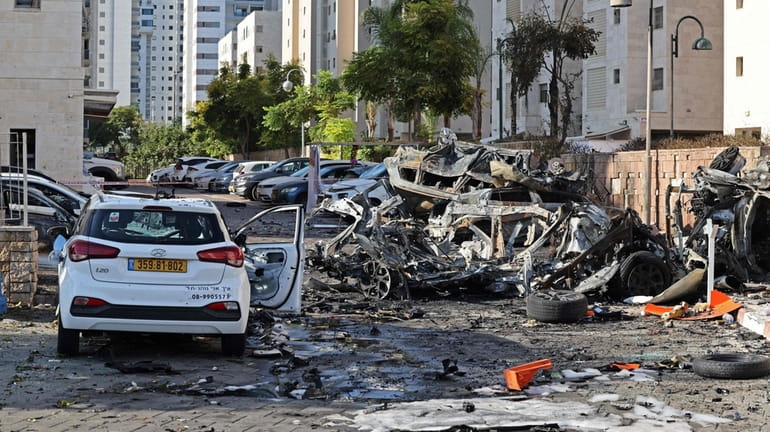 Burnt out vehicles in Ashkelon are pictured following a rocket...