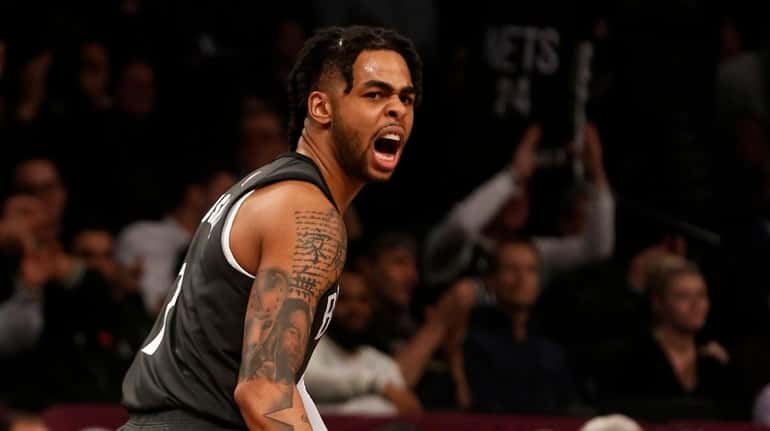 D'Angelo Russell of the Nets reacts after teammate Spencer Dinwiddie hit...
