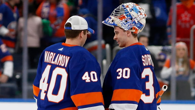 Ilya Sorokin and Semyon Varlamov of the Islanders celebrate after defeating the...