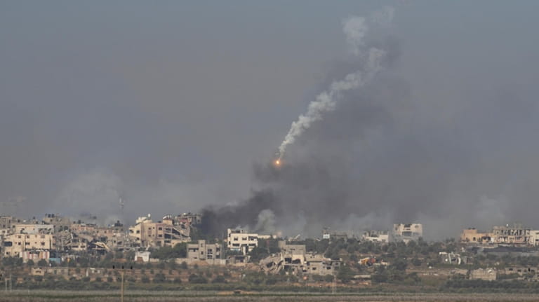 An Israeli army flare is seen over the Gaza Strip,...