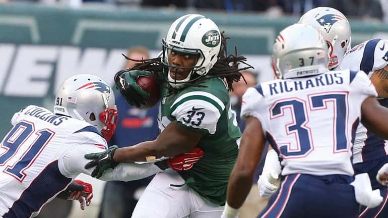 New York Jets running back Chris Ivory (33) drives by...
