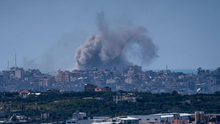 An explosion rises in the northern Gaza Strip, as seen...