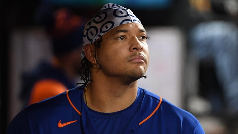 Mets starting pitcher Taijuan Walker looks out from the dugout...