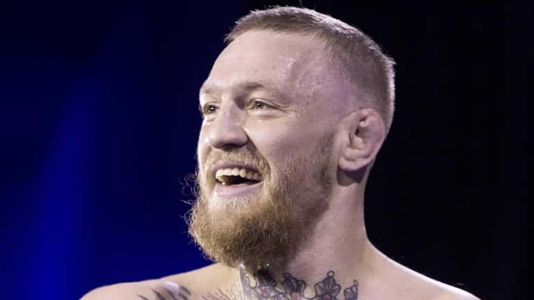 UFC featherweight champion Conor McGregor smiles during open workouts for...