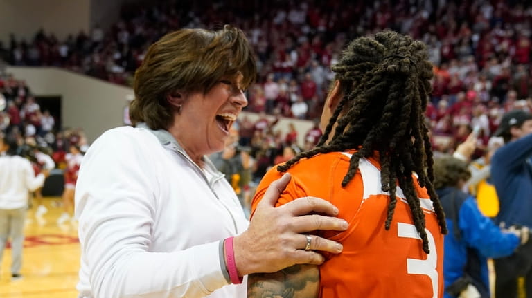 Miami head coach Katie Meier celebrates with Destiny Harden after...