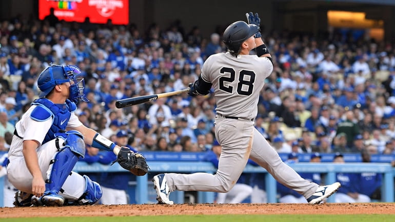 Yankees' Josh Donaldson, right, hits a solo home run as...