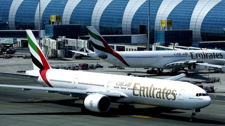 An Emirates airline passenger jet taxis on the tarmac on...