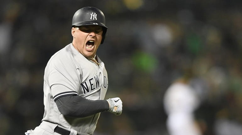 Luke Voit of the Yankees celebrates as he trots around the...