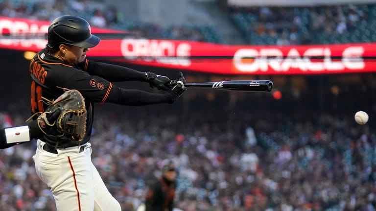 San Francisco Giants' Wilmer Flores hits a two-run single against...