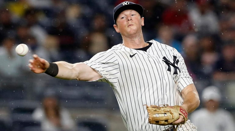DJ LeMahieu of the Yankees throws to first base during a...