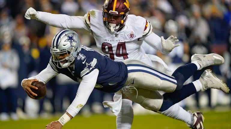 Dallas Cowboys quarterback Dak Prescott (4) leaping across with the...