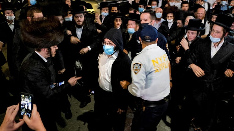 Jacob Kornbluh, a reporter for Jewish Insider, is escorted through...