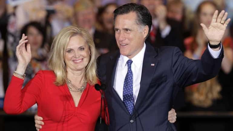 Mitt Romney and his wife Ann wave as they leave...