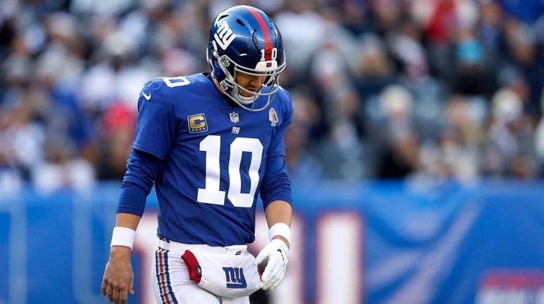 Eli Manning #10 of the New York Giants looks on...