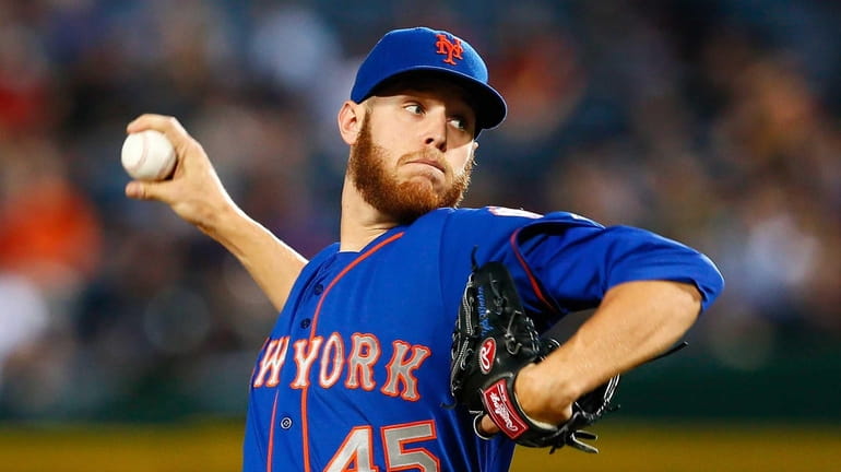 Zack Wheeler #45 of the Mets delivers a pitch in...