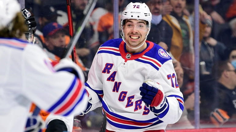 The Rangers' Filip Chytil, right, celebrates after scoring a goal...