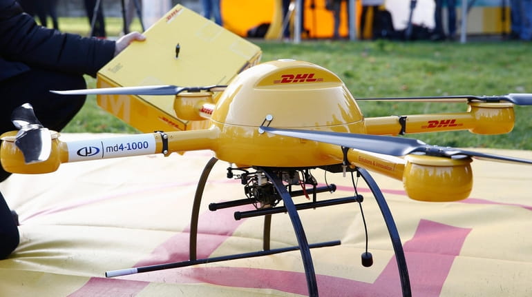 DHL partner Daniel Knoche of microdrones stands next to a...