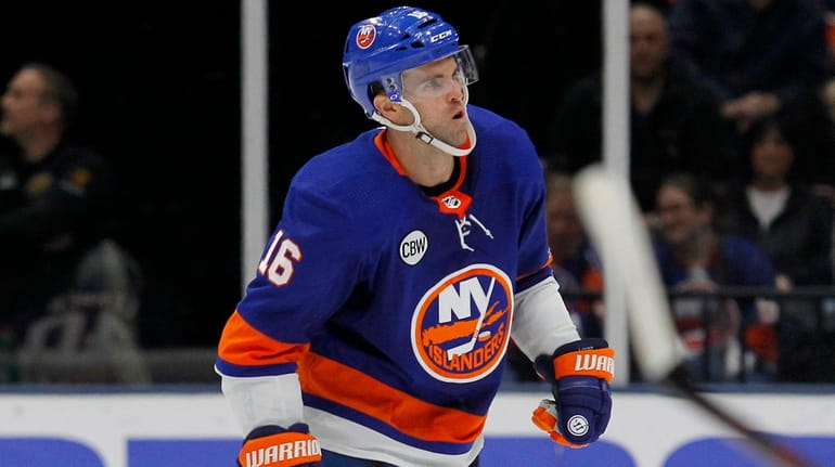 Islanders left wing Andrew Ladd limps to the bench after...