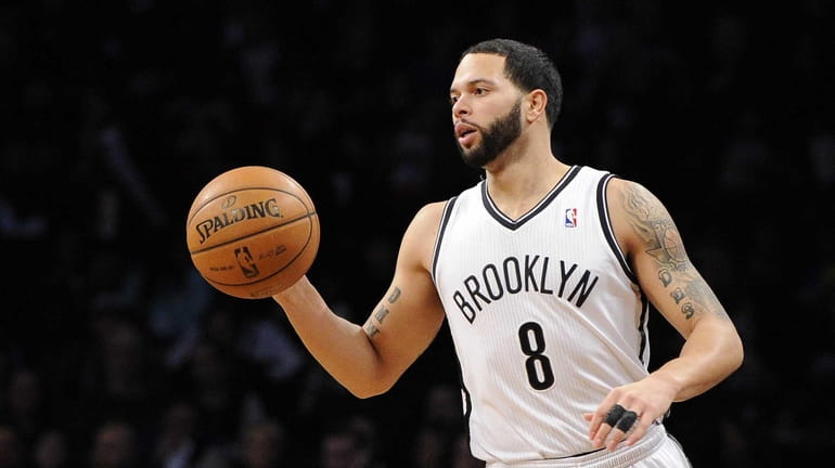 Nets guard Deron Williams controls the ball against the Cleveland...