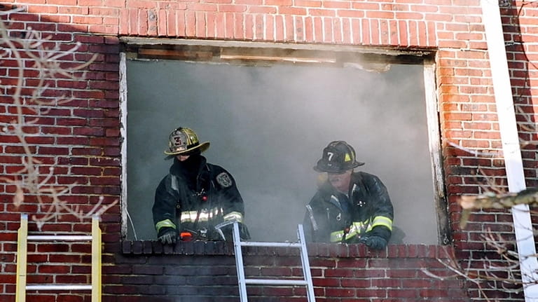 Farmingdale firefighters at the scene of a 2004 fire at...