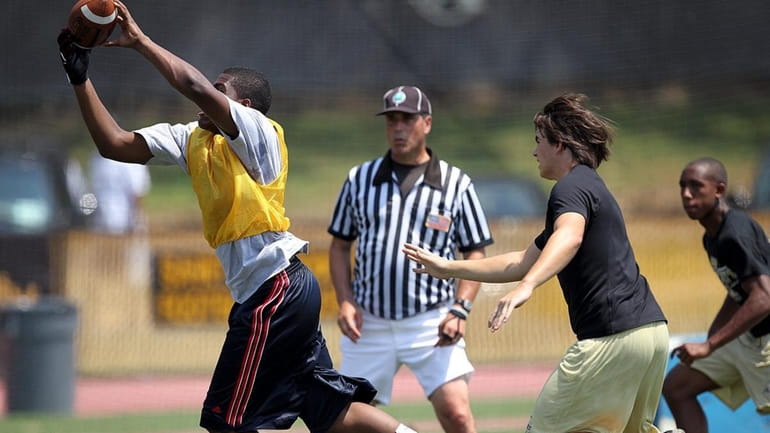 A pass is caught during a round robin 7-on-7 football...