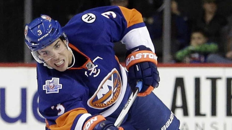 New York Islanders defenseman Travis Hamonic (3) sends the puck...