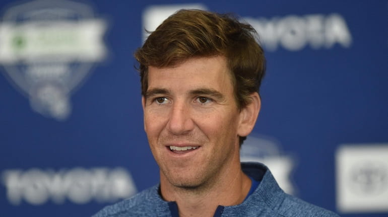 Giants quarterback Eli Manning speaks with the media after checking...