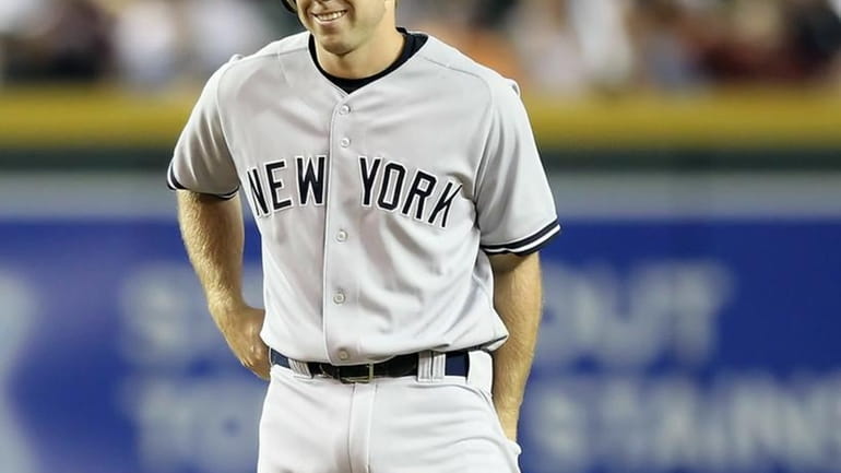 Colin Curtis #27 of the New York Yankees smiles after...