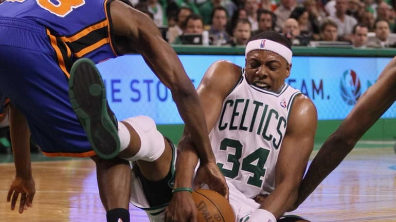 Boston's Paul Pierce fights for a loose ball with the...