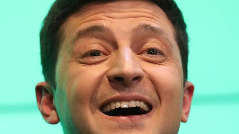Volodymyr Zelensky reacts at the briefing after the announcement of...