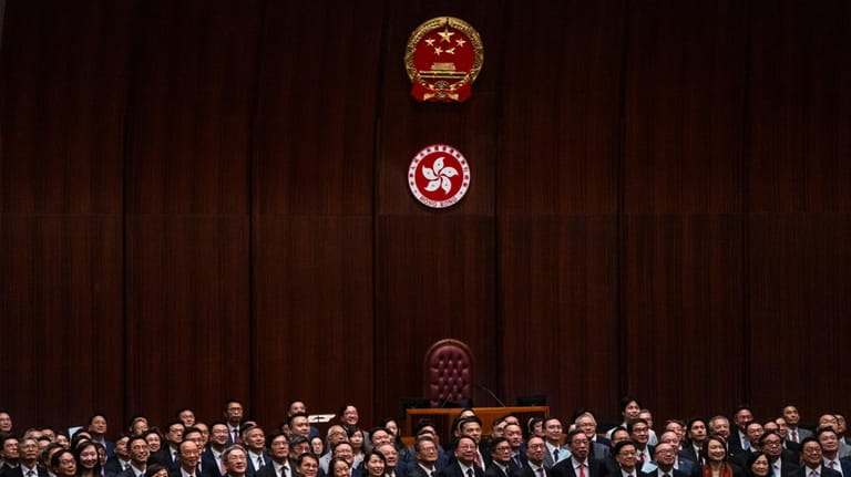 Hong Kong's Chief Executive John Lee Ka-chiu poses for photographs...