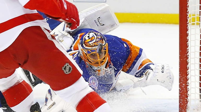 Jaroslav Halak #41 of the New York Islanders dives back...