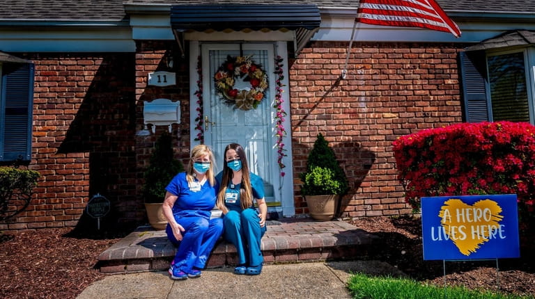 Carolyn Engel and her daughter Lauren outside their home in...