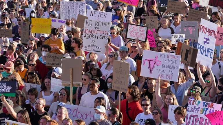 People attend an abortion-rights protest at the Utah State Capitol...