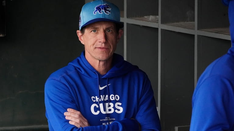 Chicago Cubs manager Craig Counsell pauses in the dugout prior...