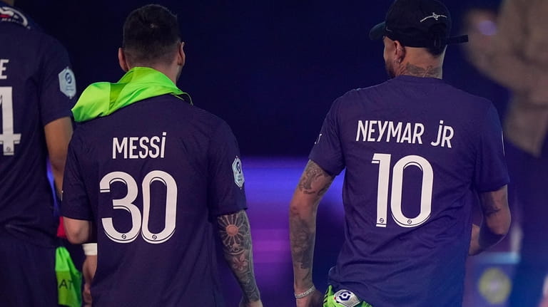 PSG's Lionel Messi, left, and PSG's Neymar walk away after...
