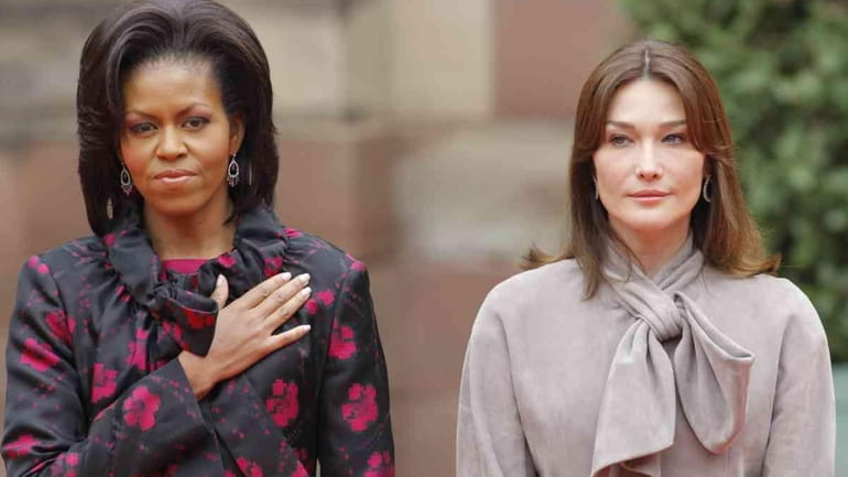 First lady Michelle Obama stands with Carla Bruni-Sarkozy, wife of...