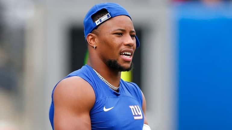 Giants running back Saquon Barkley warms up before a preseason game...