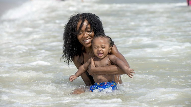 Diandra Berwayne of Brooklyn cools off with her 9 month...