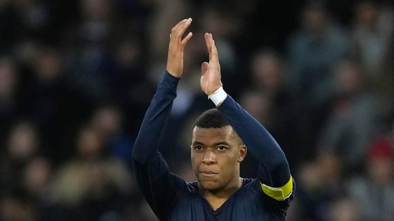 PSG's Kylian Mbappe applauds fans at the end of the...