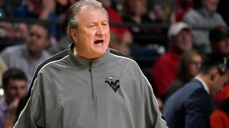 West Virginia head coach Bob Huggins calls to his players...