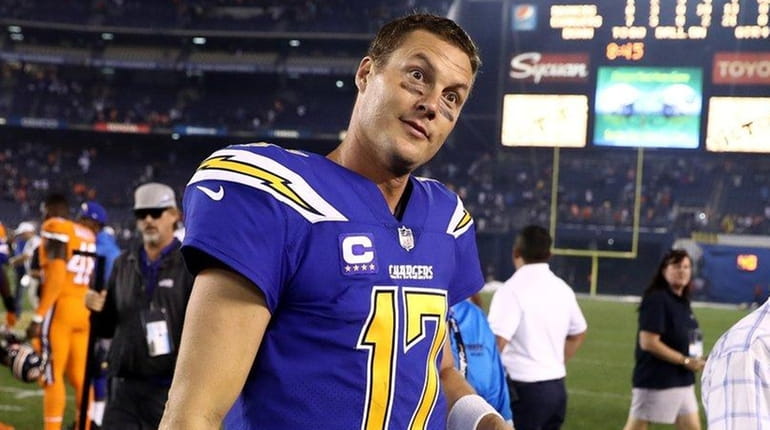 Philip Rivers #17 of the San Diego Chargers walks off...