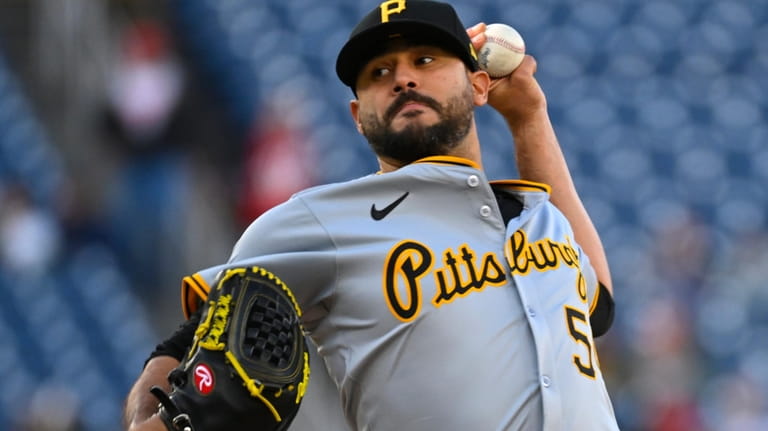 Pittsburgh Pirates starting pitcher Martin Perez winds up during the...