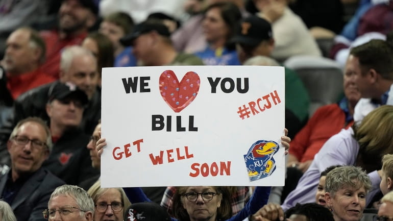 A fan holds up a get well sign for Kansas...