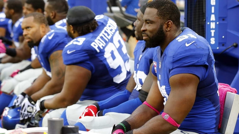 Giants defensive end Justin Tuck (no. 91) looks on from...