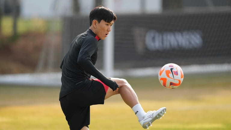 South Korea's Hwang In-beom warms up during a training session...